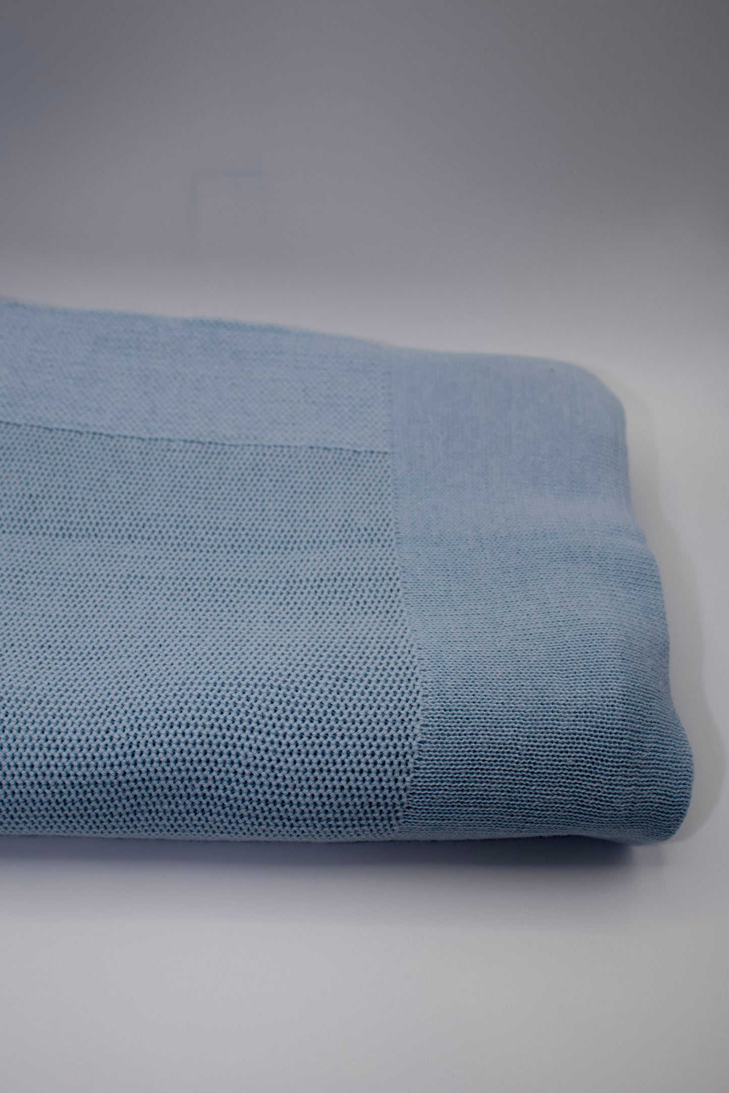Rolled-up blue fabric on a gray background