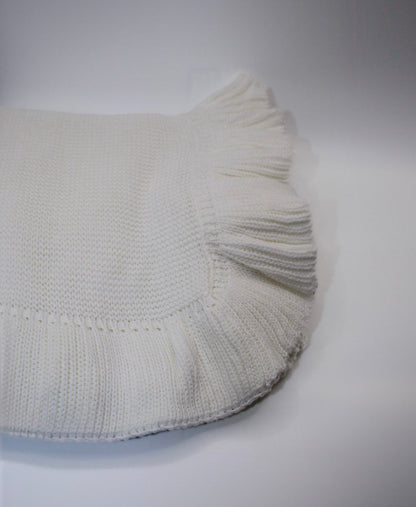 White knitted blanket on a gray background